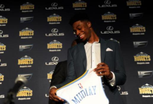DENVER, CO - JUNE 26: Emmanual Mudiay smiles as he holds his new Nuggets jersey after a press conference on Friday, June 26, 2015 at the Pepsi Center. The Denver Nuggets held an introductory press conference at the Pepsi Center to welcome 19-year-old Emmanuel Mudiay, the 7th overall NBA draft pick, to the team on Friday, June 26, 2015. (Photo by Callaghan O'Hare/The Denver Post)